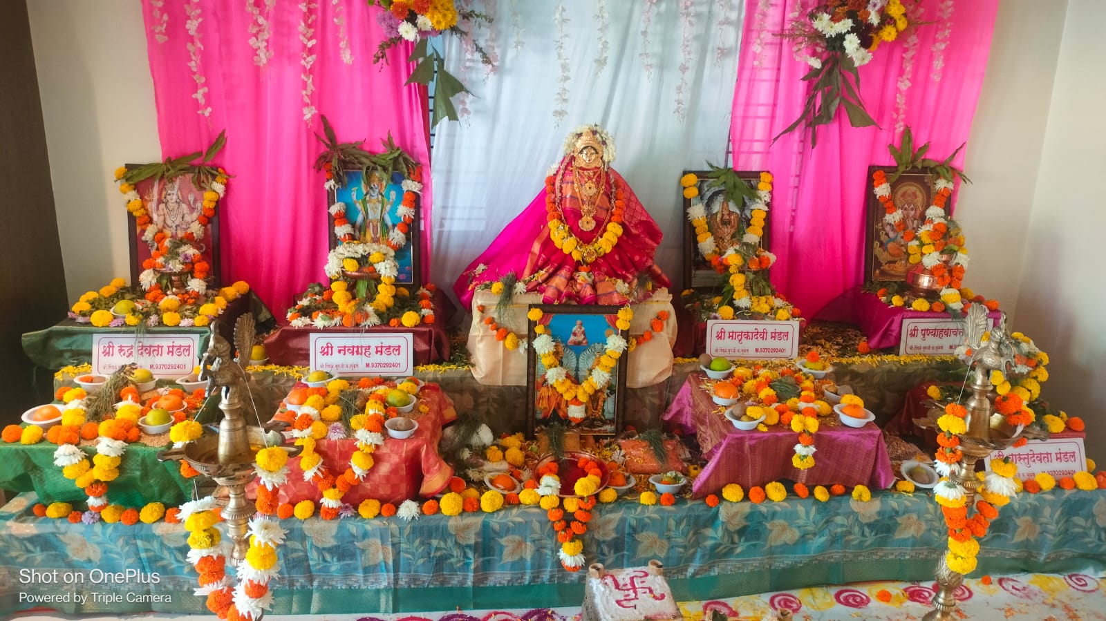 A ceremonial puja mandap prepared with deity idols, flowers, lamps, offerings, and kalash decorations for Trimbakeshwar rituals.